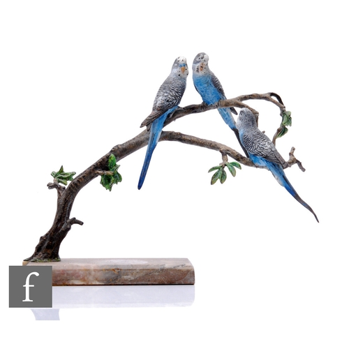 563 - An early 20th Century cold painted bronze study of three blue budgerigars perched to a branch above ... 