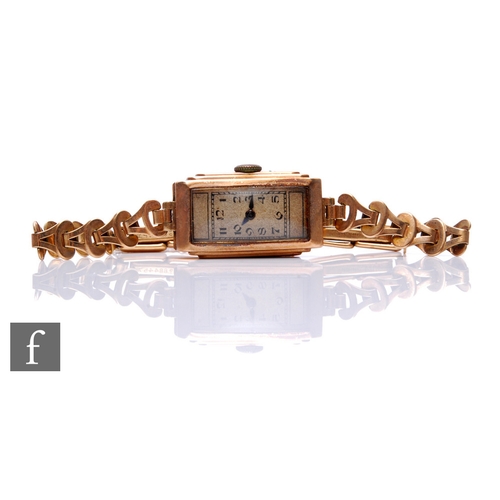 293 - A 9ct hallmarked lady's 9ct manual wind wrist watch, Arabic numerals to a rectangular dial and 9ct b... 