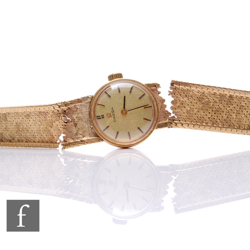 308 - A 9ct hallmarked lady's Omega wrist watch, gilt batons to a circular champagne dial and integral 9ct... 