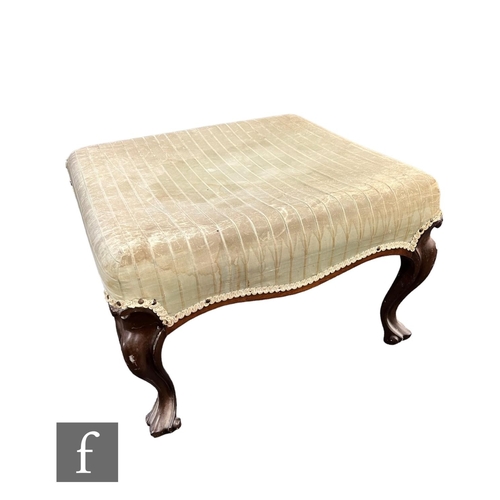 749 - A Victorian walnut dressing stool on cabriole legs and scroll feet, upholstered in stripped pale mat... 