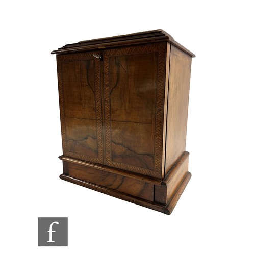 747 - A Victorian figured walnut table cabinet fitted with three drawers, recessed brass handles, enclosed... 