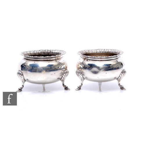 15 - A pair of hallmarked silver open cauldron salts, each raised on three stepped feet, total weight 5.5... 