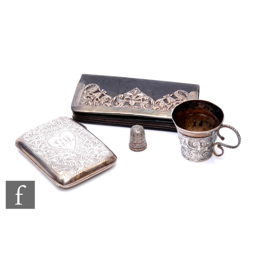 16 - Four items of hallmarked silver to include a cigarette case, a leather silver mounted purse, a thimb... 