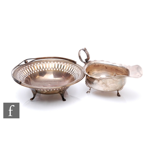 20 - A hallmarked silver sauce boat of typical form, Birmingham 1906, with a Canadian Sterling silver cir... 