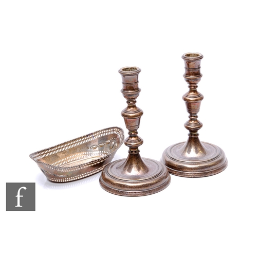 42 - A pair of hallmarked silver candlesticks, stepped circular bases below knopped columns, heights 19cm... 