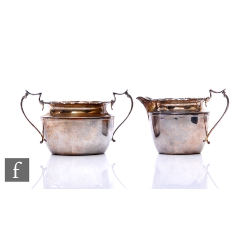 44 - A hallmarked silver cream and sugar of plain form with crimped borders, total weight 7.5oz, Birmingh... 