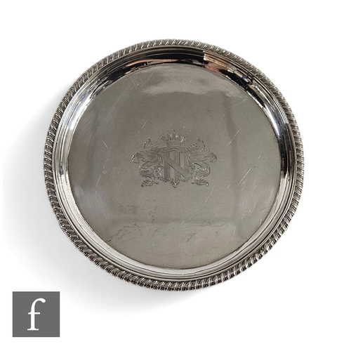 50 - A hallmarked silver circular slaver with engraved central crest within a rope twist borders, weight ... 