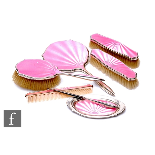 52 - A hallmarked silver and pink enamel decorated seven piece brush set to include hand mirror pin tray,... 