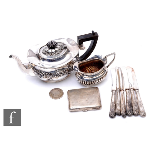 62 - A small parcel lot of assorted hallmarked silver to include a tea pot, Georgian crown, cream jug and... 