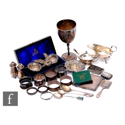 63 - A parcel lot of assorted hallmarked silver items to include a goblet, condiments, a cased pair salts... 