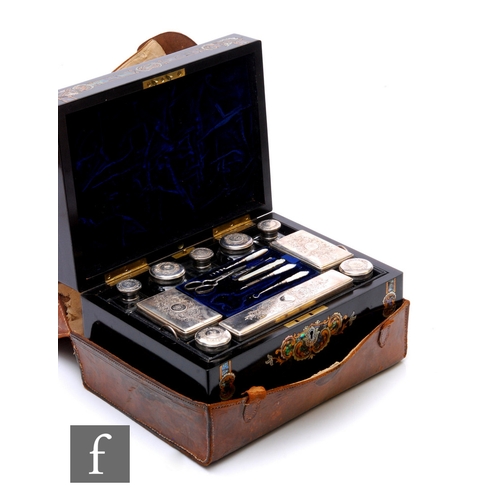 65 - A silver plated and clear cut glass travelling vanity box, the ebonised case with inlaid abalone she... 