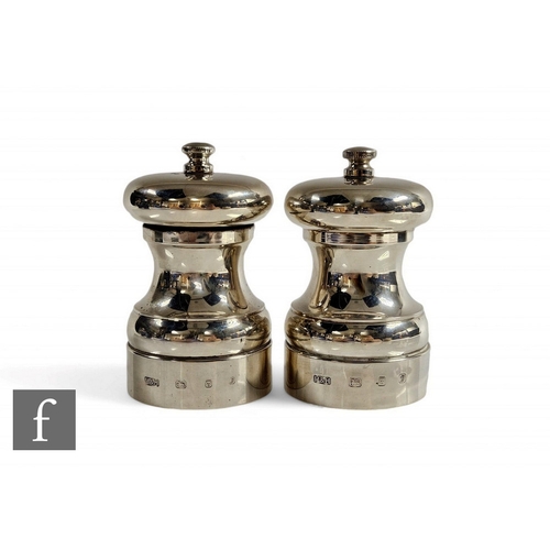 11 - A hallmarked silver salt and pepper grinder each of plain baluster form, total weight 450g, heights ... 