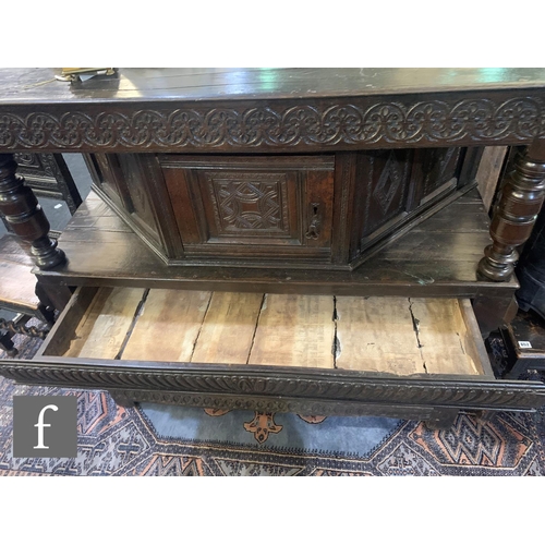 665 - A 17th Century and later constructed two tier oak buffet, the moulded edge plank top above an angled... 