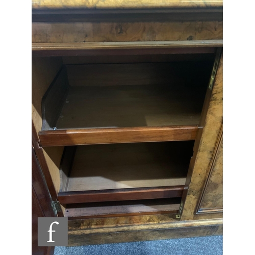 716 - A Victorian figured walnut linen cupboard enclosed by four moulded arched doors, fitted with sliding... 