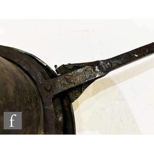 479 - A 17th Century brass warming pan, the domed centre engraved with scroll and leaf design and the oute... 