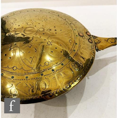 479 - A 17th Century brass warming pan, the domed centre engraved with scroll and leaf design and the oute... 