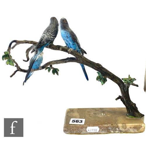 563 - An early 20th Century cold painted bronze study of three blue budgerigars perched to a branch above ... 