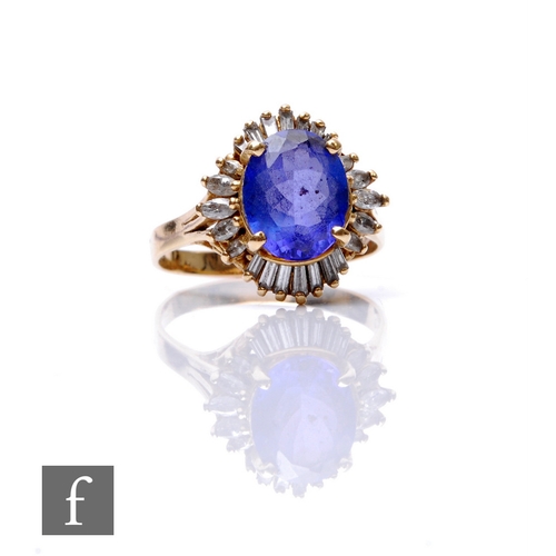 247 - A 14ct tanzanite and diamond cluster ring, central oval tanzanite within a border of tapering baguet... 