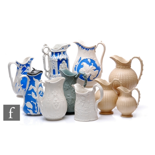 101 - A collection of mid 19th Century jugs, including three Copeland 'drab ware' relief moulded jugs of g... 