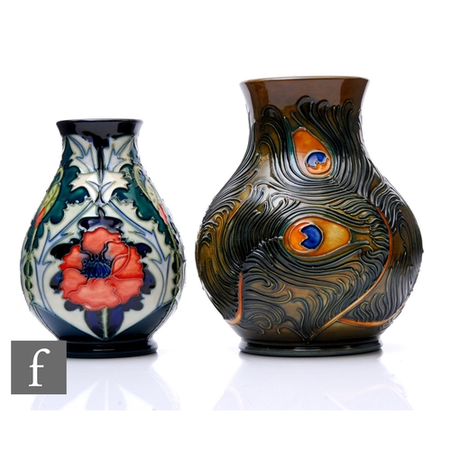 A Moorcroft Pottery Pheonix pattern vase by Rachael Bishop, tubeline decorated with peacock feathers over green ground, painted and impressed marks, second quality, height 16cm, vase, together with a Moorcroft Pottery poppy vase by Rachael Bishop, second quality, height 13cm. (2)