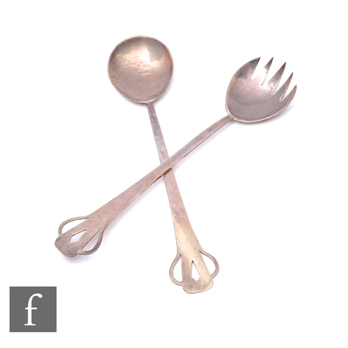 77 - A pair of Arts and Crafts hallmarked silver salad servers each with pierced details to terminals, Lo... 