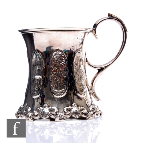 80 - A Victorian hallmarked silver tankard with panelled decoration of farming scenes, terminating in scr... 