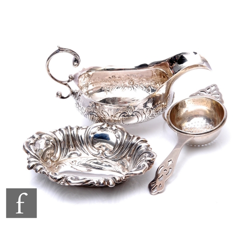 81 - Three items of hallmarked silver to include a sauce boat, tea strainer and a small pin dish, total w... 