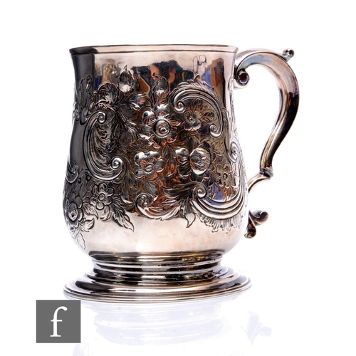 82 - A George II hallmarked silver tankard with later embossed foliate decoration, weight 11oz, height 11... 