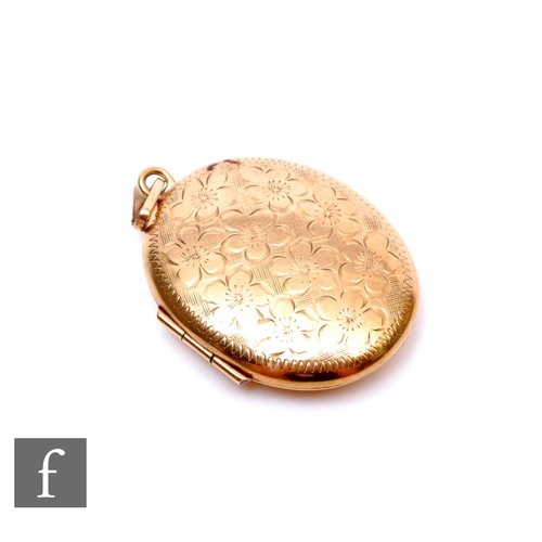 259 - A 9ct hallmarked oval locket. weight 10.5g, with engraved floral decoration to front.