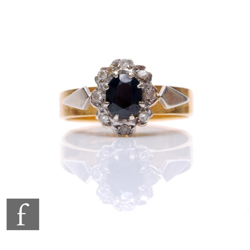 267 - An 18ct hallmarked sapphire and diamond cluster ring, central sapphire within diamond set border, we... 