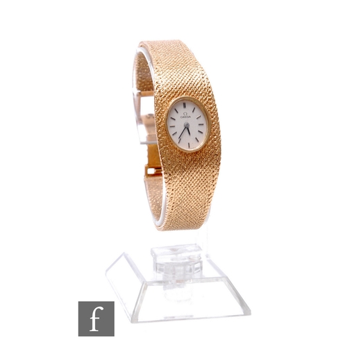 321 - A 1970s lady's 9ct hallmarked Omega, manual wind wrist watch, batons to an oval silver dial and inte... 