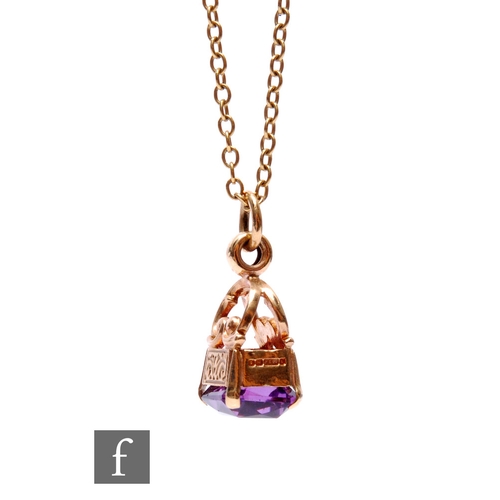 275 - A amethyst pendant with 9ct mount with scrolling foliate design, suspended on a yellow metal trace l... 