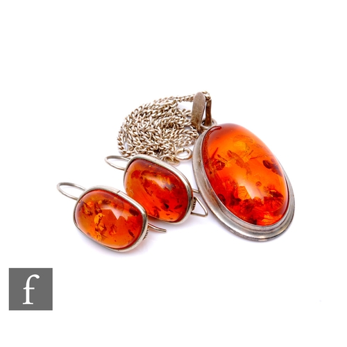 286 - A silver mounted Baltic amber pendant and drop earrings, pendant length, length of chain 52cm. (3)