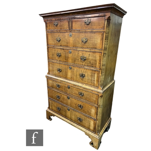 620 - An 18th Century feather banded figured walnut chest on chest, the upper section fitted with two shor... 