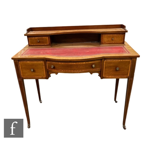 647 - An Edwardian crossbanded mahogany bow front writing desk fitted with three drawers below a super str... 