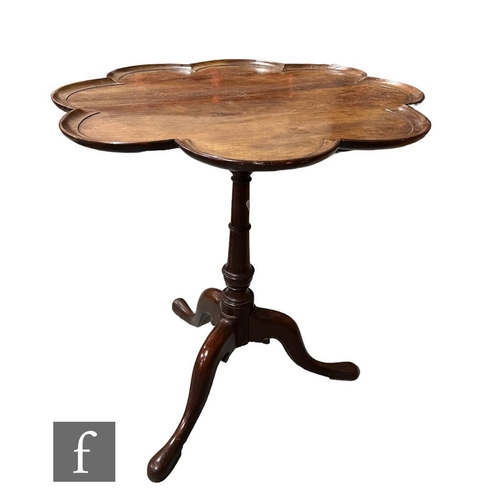 604 - A small 19th Century mahogany snap top tripod supper table, the shaped dished top on a turned pedest... 