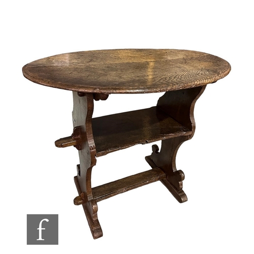 622 - A small oak oval monk's bench of peg construction, the oval top above a single tier flanked by shape... 