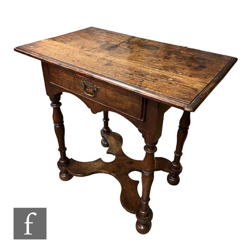 595 - An 18th Century and later constructed oak side table, the moulded edge top over a small frieze drawe... 