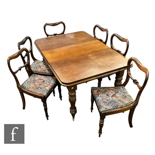 635 - A Victorian mahogany extending dining table, the moulded edge top over a plain frieze on turned balu... 