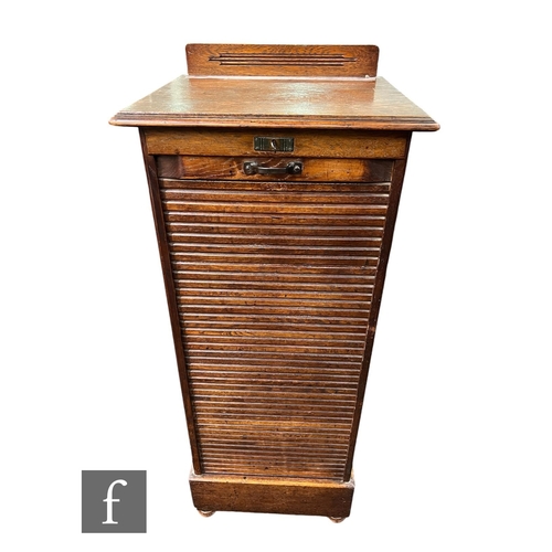 600 - A 1930s oak filing cabinet enclosed by a tambour shutter door, height 121cm x depth 45cm x width 48c... 