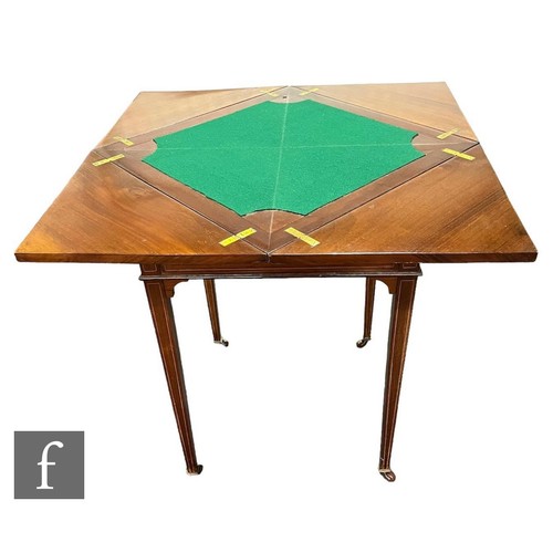 624 - An Edwardian satinwood crossbanded envelope card table on square tapering legs terminating in spade ... 