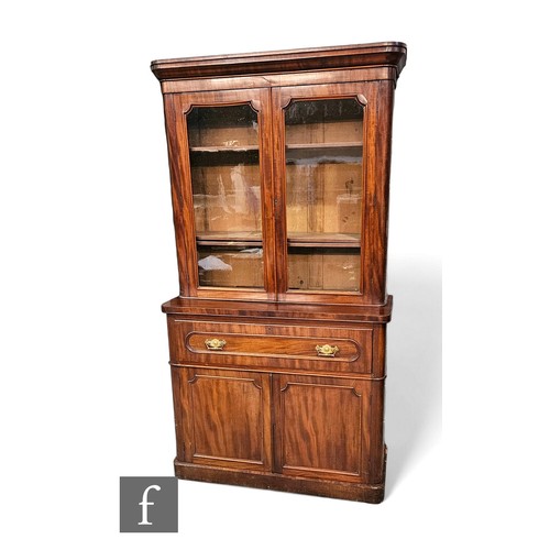 625 - A Victorian mahogany secretaire bookcase enclosed by a pair of arch glazed doors below a fluted corn... 