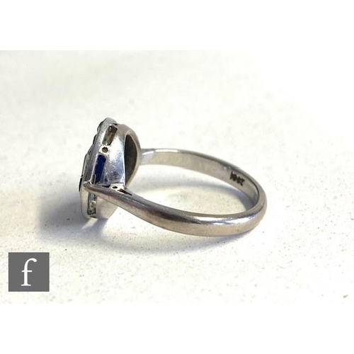 264 - An Art Deco 18ct white gold sapphire and diamond ring, circular head set with central emerald cut sa... 