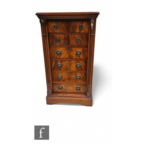 654 - A Regency style mahogany wellington chest fitted with four short drawers over four long drawers, enc... 