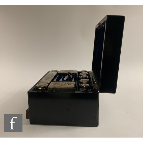 65 - A silver plated and clear cut glass travelling vanity box, the ebonised case with inlaid abalone she... 