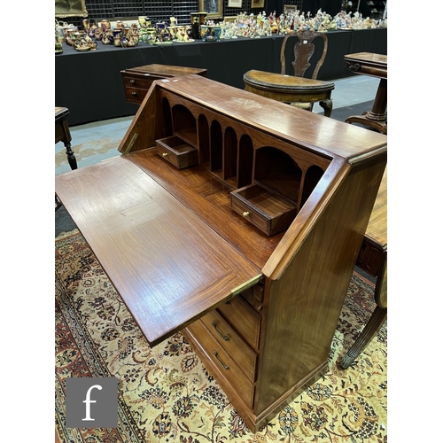 590 - A 20th Century Eastern hardwood bureau, the fitted interior enclosed by a fall inlaid with floral br... 