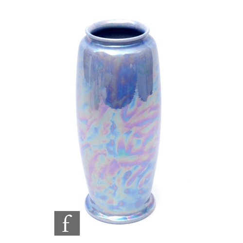 124 - Ruskin Pottery - A lavender lustre vase of shaped rolling pin form with everted rim, mottled lavende... 