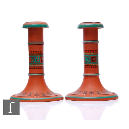 46 - In the manner of Christopher Dresser - Watcombe or Torquay Pottery - A pair of terracotta candlestic... 