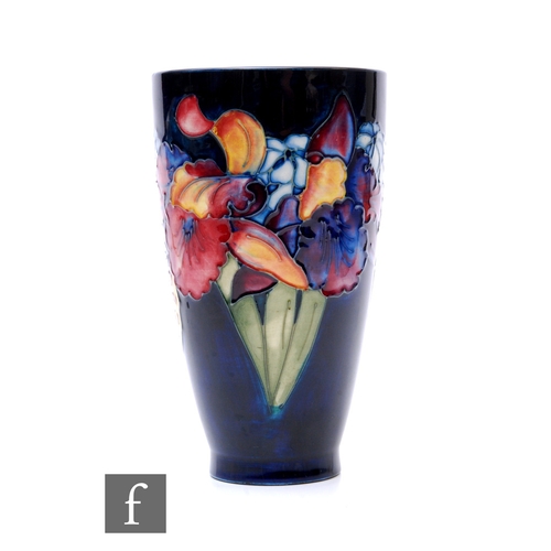 80 - Walter Moorcroft - Moorcroft - An Orchid vase of flared beaker form, tubeline decorated with stemmed... 