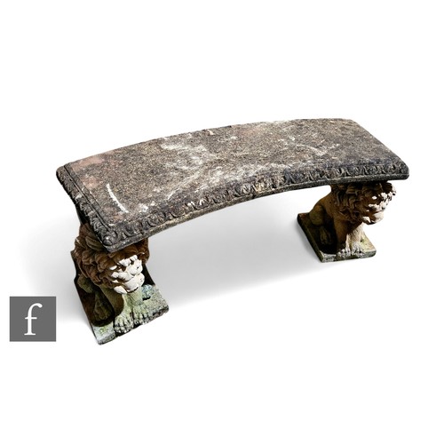 569 - A 20th Century composite stone concave shaped garden seat supported by two seated lions, on plinth b... 